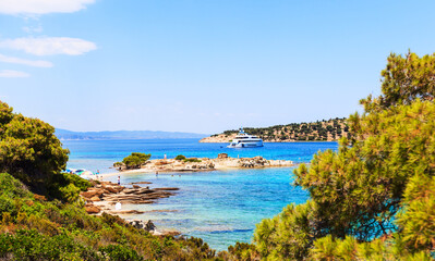 Impressive summer seascape of turquoise sea water and yacht at coast.