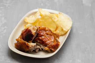 crispy tasty baked piglet and potato in ceramic dish