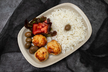 Chicken meatballs with salad and boiled rice