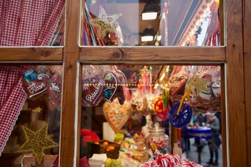 Fototapeta premium Candy heart cookies and Christmas decorations seen throw window in a German store