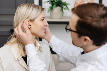 A young attractive otolaryngologist doctor gives a consultation to a female patient. A doctor...
