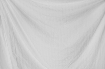 Top view of wrinkles on an unmade bed sheet after waking up in the morning.