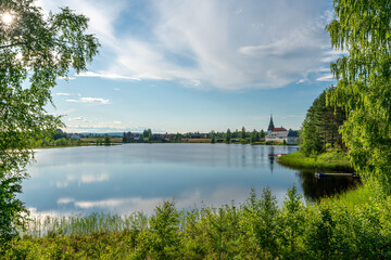Fototapeta na wymiar Beautiful summer view from a lake in a countryside village