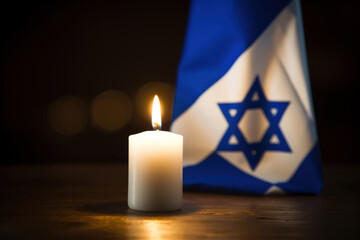  Lit candle with Israeli flag in background