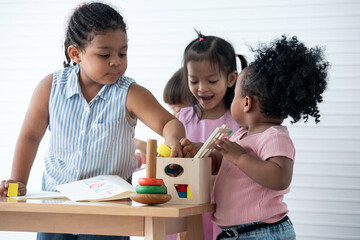 Happy diversity group of 2-4 year olds playing educational toys together, group study concept