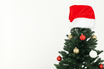 Christmas, decorated tree with a Santa hat on top.