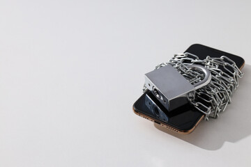 The smartphone is encased in a chain with a lock