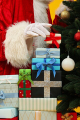 Christmas concept. Santa put presents under the tree.
