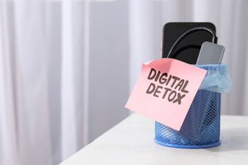 The concept of digital detoxification, a smartphone in a trash can