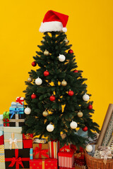 Christmas, decorated tree with a Santa hat on top.