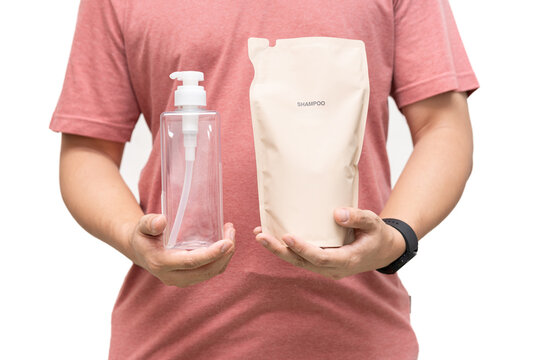 Man choosing shampoo plastic packaging for refill pouch isolated on white background. Zero waste. Reuse reduce recycle concept.