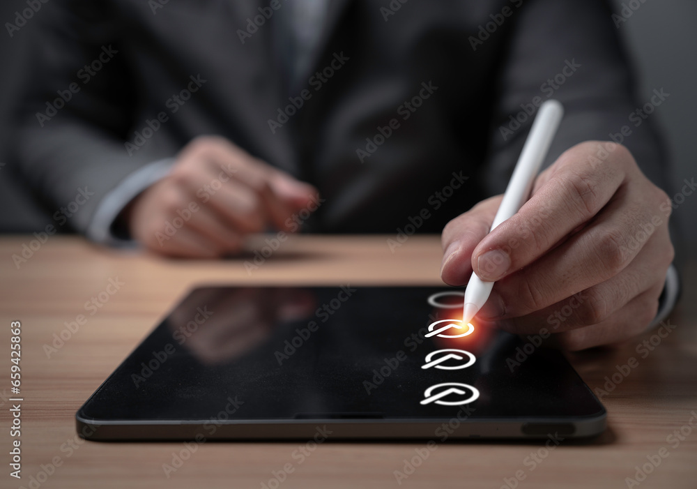 Poster Businessman using electronic pen to tick approve on tablet for ISO quality assurance control and project approve concept.