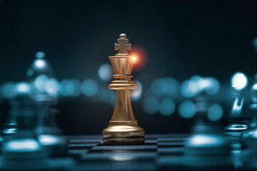 Golden king chess encounters with silver chess enemy on chess board and black background. Market or...