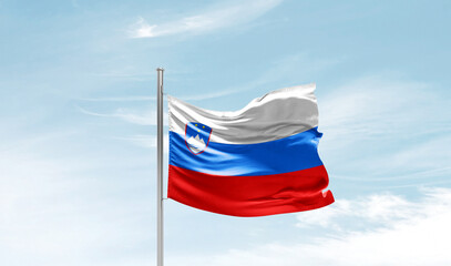 Slovenia national flag waving in beautiful sky. The symbol of the state on wavy silk fabric.