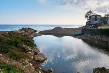 Puddle meddling with the sea in the morning at Akcakoca, Duzce province, Turkiye.