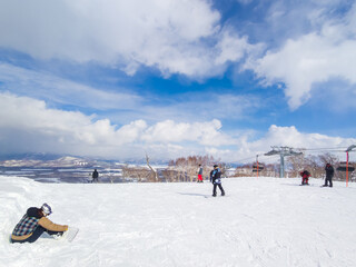 People enjoying wide ski slopes with the view (Niseko, Hokkaido, Japan)