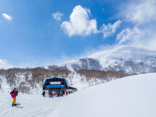 Fototapeta na wymiar View of the ski resort summit over a chairlift station (Niseko, Hokkaido, Japan)