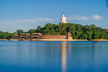 The white pagoda in Beihai Park in Beijing is reflected in the calm water.