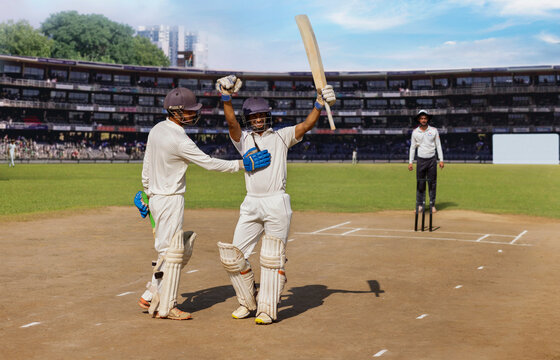 Batsman waving to the Pavillion/crowd to acknowledge the applause  , during a cricket match