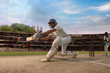 Cricketer batsman hitting a sweep shot during a cricket  match on the pitch
