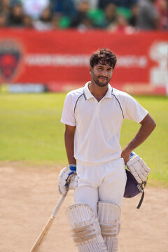 Portrait of a Cricket player standing with bat