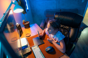 A child sitting in front of a computer screen in a dimly lit room, surrounded by neon lights,...