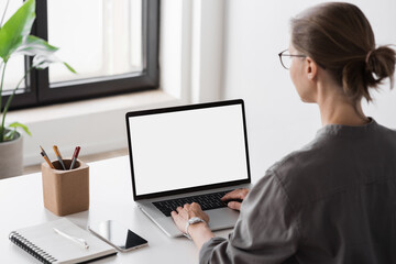 Young woman working at office, Student girl using laptop computer with blank empty screen, work or studying from home, freelance, online learning, distance education concept - 659436448