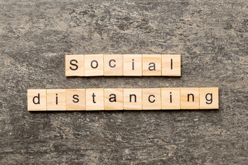 social distancing word written on wood block. social distancing text on cement table for your desing, concept