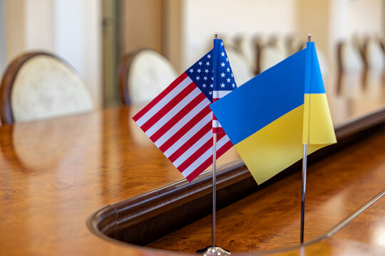 flags of United States and Ukraine. international negotiations. conclusion of contracts between countries. concept of communication between representatives of two countries. - Powered by Adobe