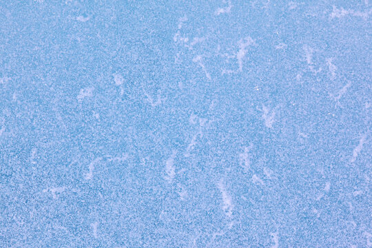 Texture of winter ice surface. Blue natural ice background