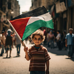 Enfant palestinien tenant le drapeau palestinien, dans la rue de Ramallah - obrazy, fototapety, plakaty