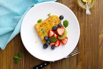 french toast with fruits on white plate