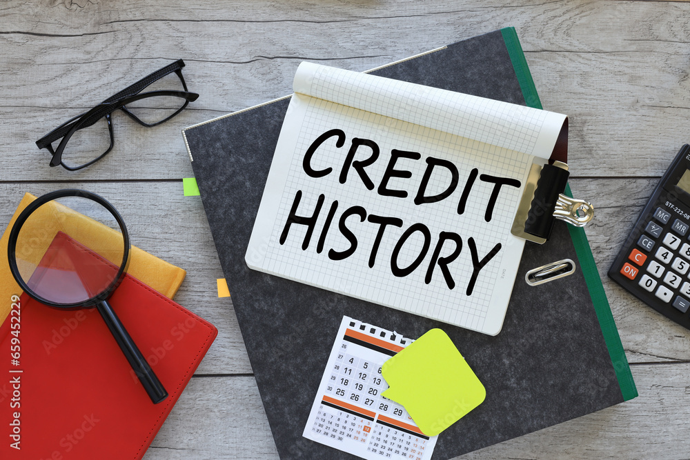 Poster credit history text on a notebook on a folder. red notepad. magnifying glass