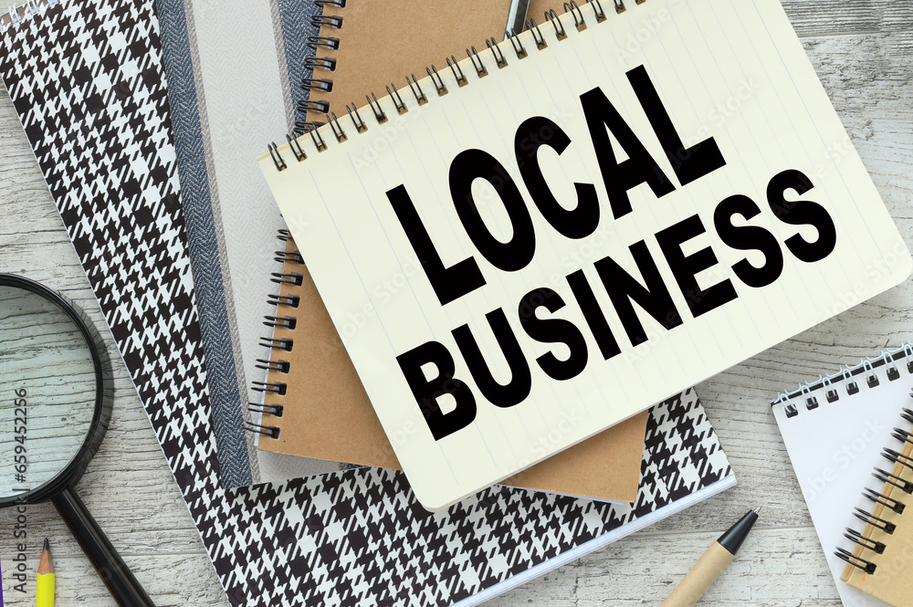 Poster text on the page. pen points to text local business
