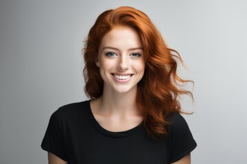 Fototapeta premium Portrait of a cute redhead model wearing casual blank clothes and smiling. Isolated on a plain colored background. Generative AI.