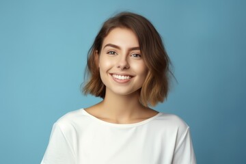 Fototapeta premium Portrait of a joyful lady model wearing casual blank clothes and smiling. Isolated on a plain colored background. Generative AI.
