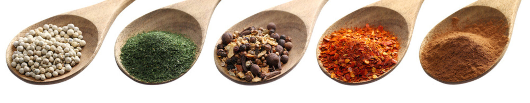 Set different spices, grain white pepper, dry chopped dill, mix garam masala, spicy chili red pepper flakes, pile cinnamon powder in wooden spoon, isolated on white, clipping