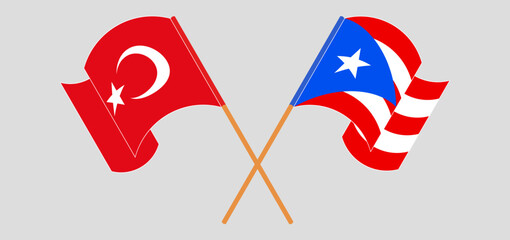 Crossed and waving flags of Turkiye and Puerto Rico