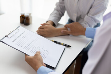 Doctor diagnosing a woman's illness in a hospital examination room, disease treatment from specialists. Medical treatment and health consultation. General health checkups and women's health problems.