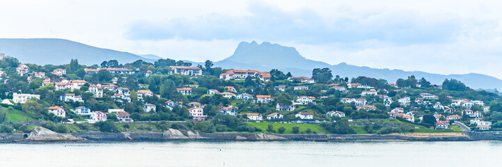 Aiako Harria or Penas de Aya mountains and houses of the seaside of Ciboure, France