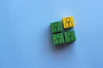 Wooden blocks with people icon on a blue background. Togetherness, diversity and inclusion,...