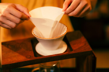 People use coffee making equipment and tools at home kitchens to brew hot coffee that drips into their cups, Professional barista preparing coffee over coffee maker and drip kettle