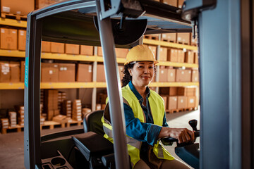 Portrait of young female forklift operator working in a warehouse