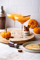 Halloween, Thanksgiving or fall cocktail pumpkin martini, homemade festive seasonal drink pumpkintini with cinnamon