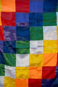 Close up image of a silk Wiphala Flag - a symbol commonly used to represent native peoples of the Andes. vertical photo
