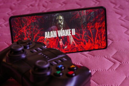 October 9, 2023, Brazil. In this photo illustration, the Alan Wake 2 logo is displayed on a smartphone screen, next to a gamepad.