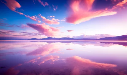 Deurstickers Salt flats covered in water with cotton candy clouds and distant mountains. © Feathering Flower