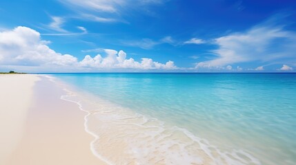 Tropical summer beach with golden sand, turquoise ocean and blue sky.