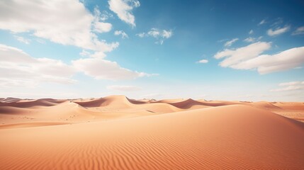 Fototapeta na wymiar Desert with a blue sky and the sun shining on it