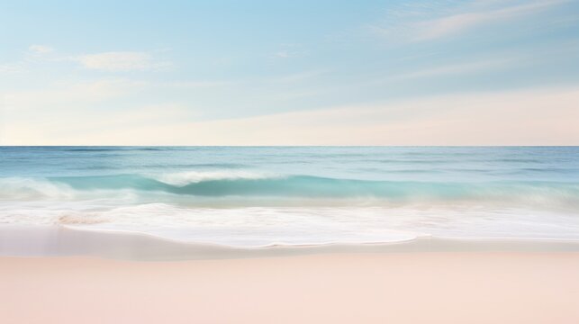 A beach with a pastel colored sky and the ocean in the background.